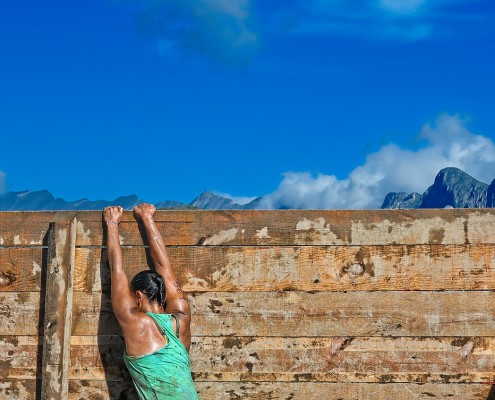 Una donna che supera l'ultimo ostacolo di una competizione sportiva